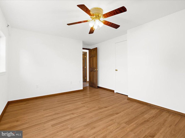 empty room with light wood-type flooring and ceiling fan