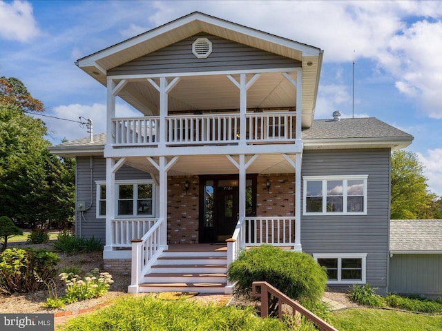 view of front facade featuring a balcony and covered porch