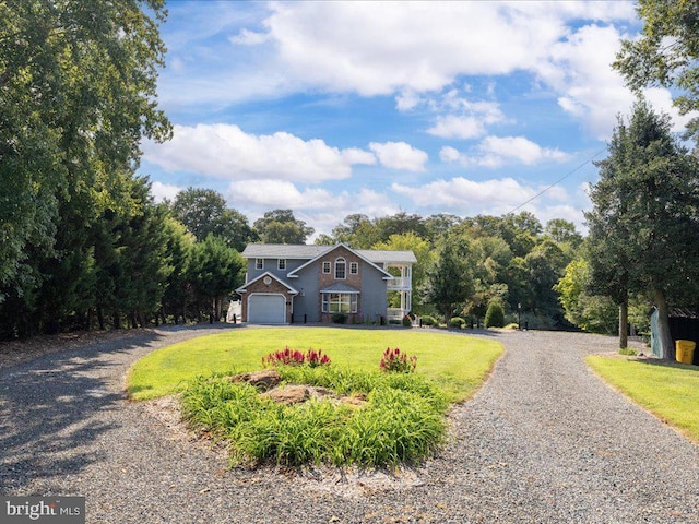 view of front of house featuring a front yard and a garage