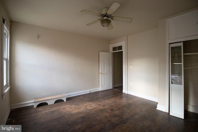 unfurnished bedroom featuring dark hardwood / wood-style flooring, a closet, and ceiling fan