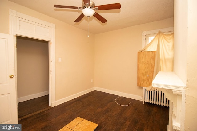 unfurnished bedroom featuring dark hardwood / wood-style flooring and ceiling fan