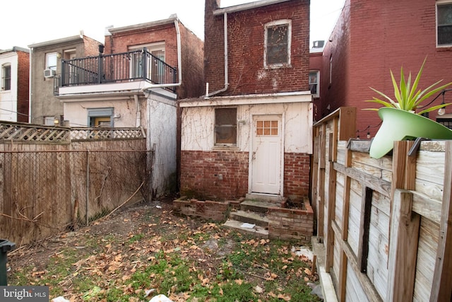 back of property with a balcony