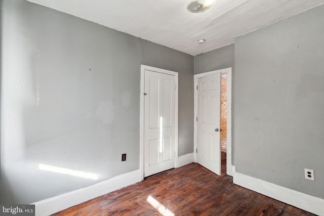 empty room featuring dark hardwood / wood-style flooring