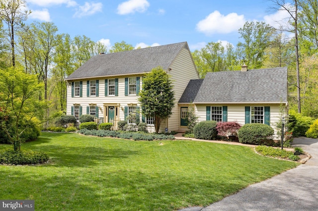 colonial inspired home with a front yard