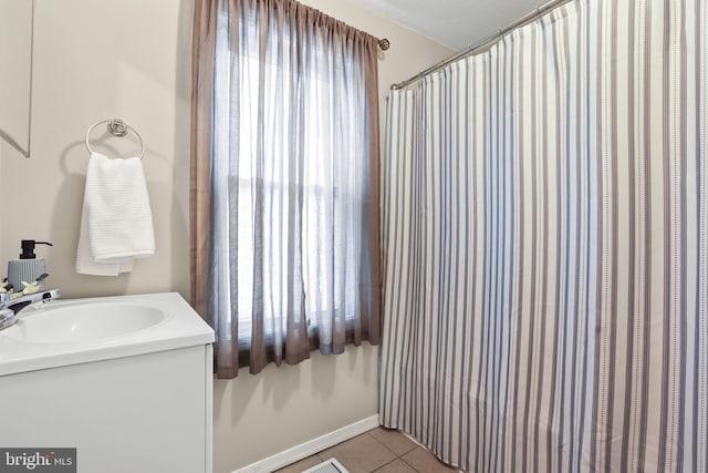 full bath with tile patterned flooring, vanity, and baseboards