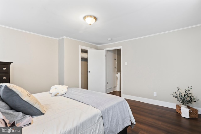 bedroom with dark wood-style floors, ornamental molding, and baseboards