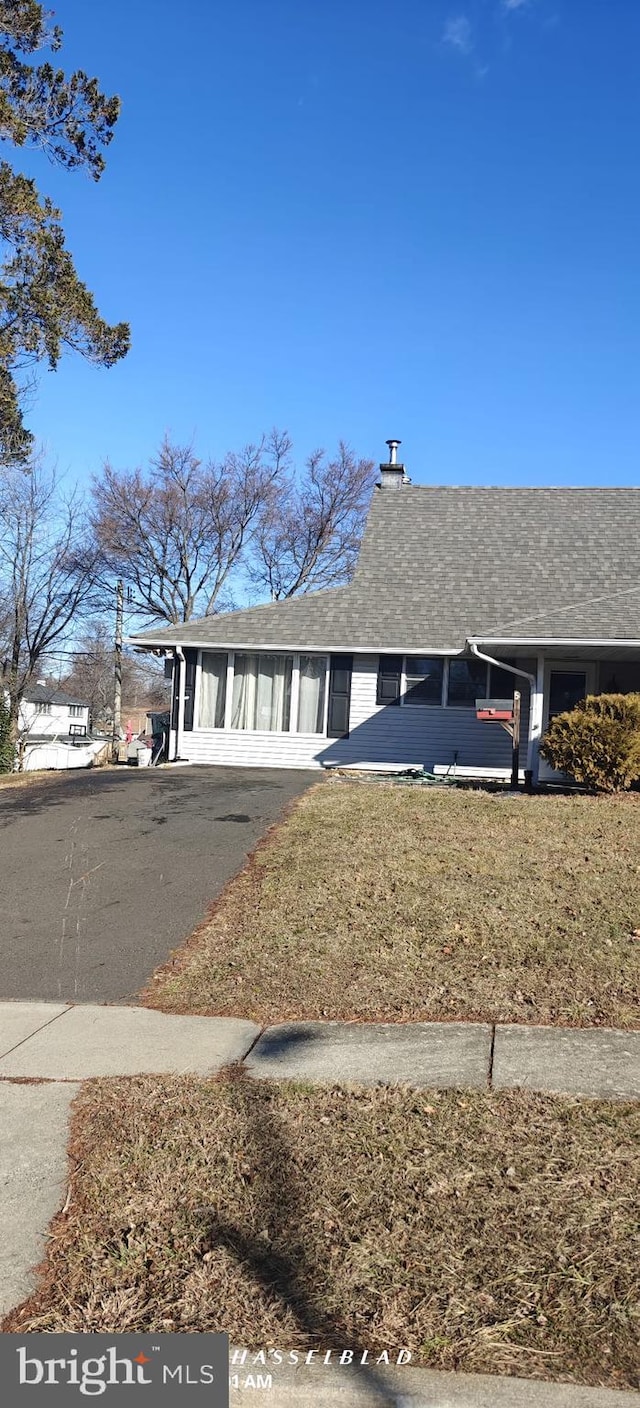 single story home with a front lawn and a carport