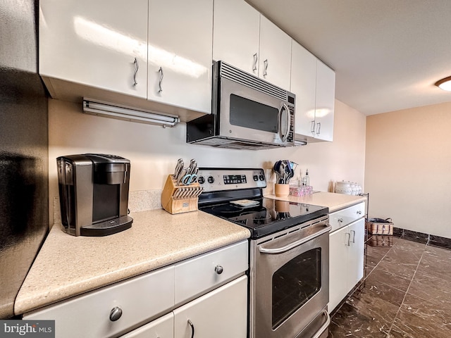 kitchen featuring white cabinetry and appliances with stainless steel finishes