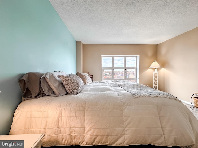 carpeted bedroom featuring a textured ceiling