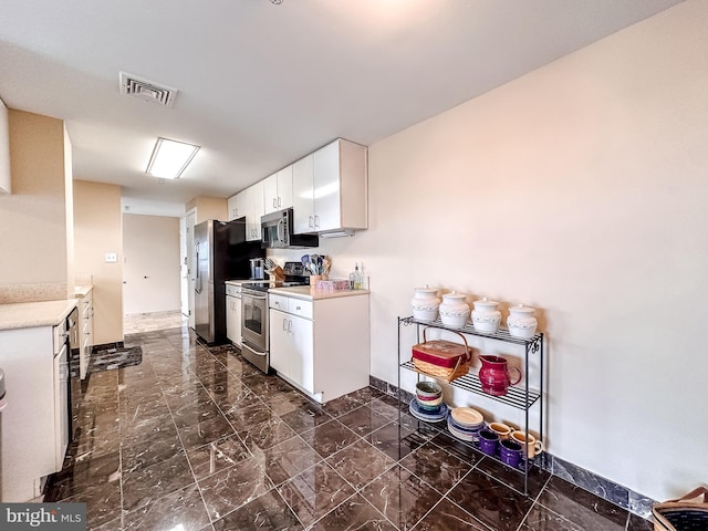 kitchen featuring white cabinets and stainless steel appliances