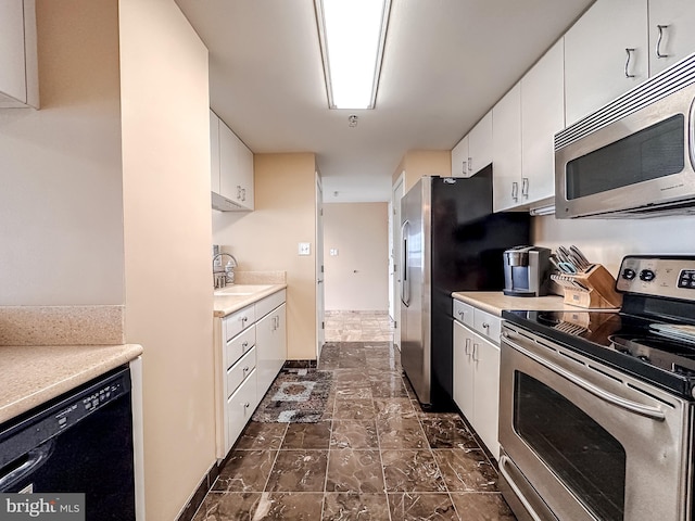 kitchen with white cabinetry, sink, and appliances with stainless steel finishes