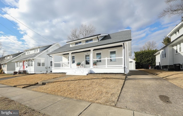 view of front of property with a porch and an outbuilding