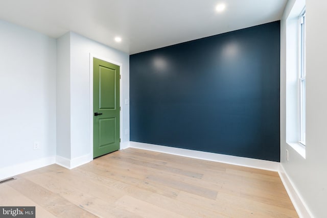 unfurnished room with light wood-type flooring