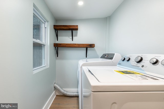 laundry room featuring washer and dryer and wood-type flooring