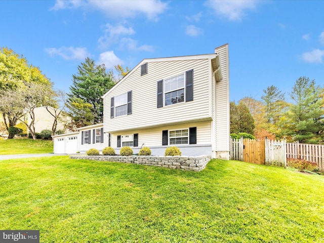 view of front of house featuring a front yard and a garage