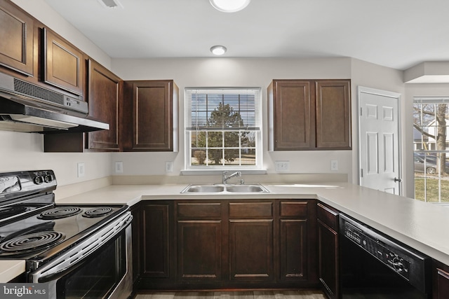 kitchen with exhaust hood, dark brown cabinetry, sink, and black appliances