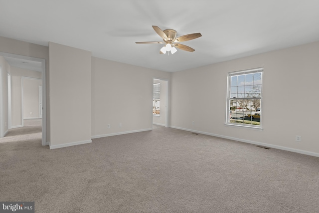 carpeted empty room featuring ceiling fan