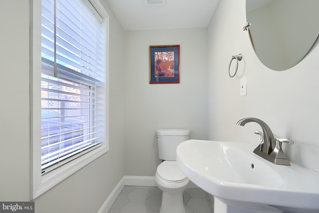 bathroom featuring sink, tile patterned flooring, and toilet