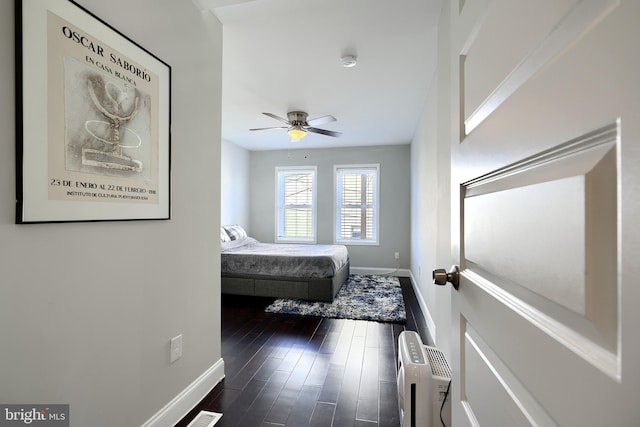 bedroom featuring radiator, dark hardwood / wood-style flooring, and ceiling fan