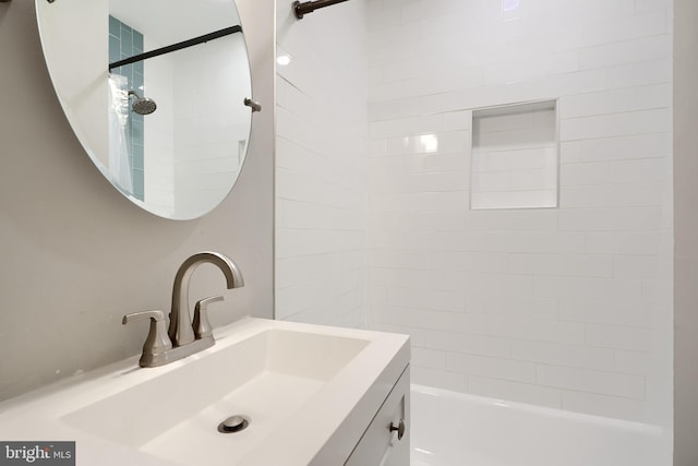 bathroom featuring vanity and tiled shower / bath