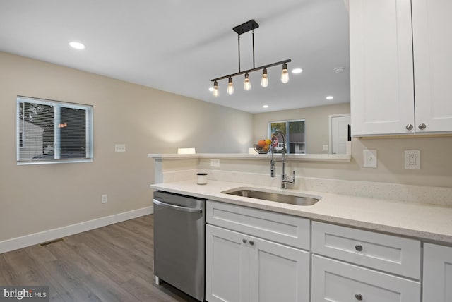 kitchen with light stone countertops, white cabinets, sink, dishwasher, and hanging light fixtures