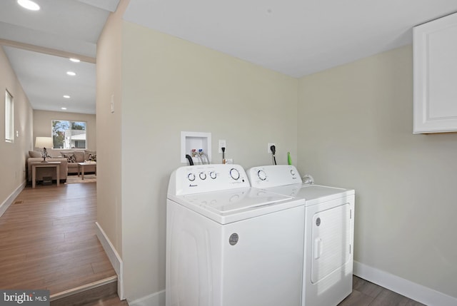 laundry room featuring washer and clothes dryer and dark hardwood / wood-style flooring