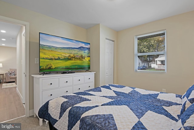 bedroom featuring a closet and light colored carpet