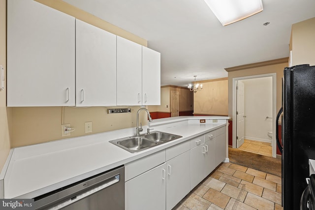 kitchen with pendant lighting, white cabinets, black refrigerator, sink, and stainless steel dishwasher