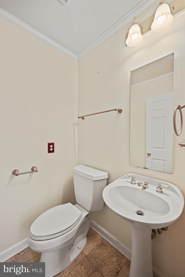 bathroom featuring toilet and ornamental molding