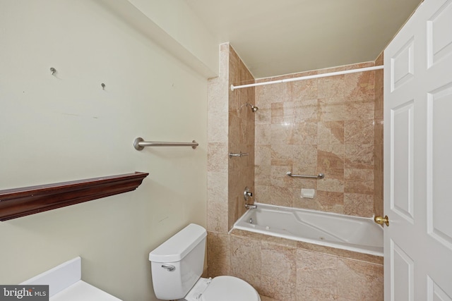 bathroom featuring toilet and tiled shower / bath