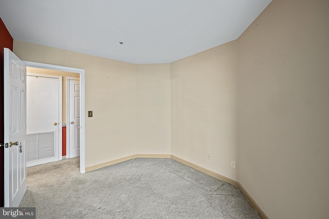 spare room with light colored carpet