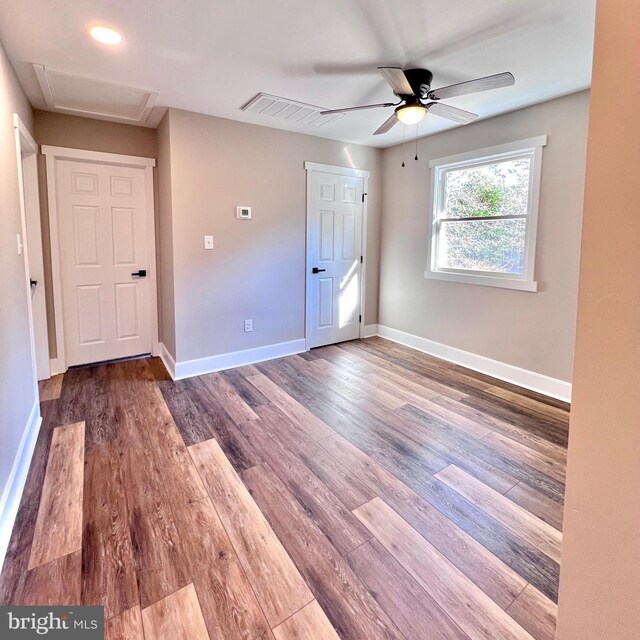 spare room featuring hardwood / wood-style floors and ceiling fan