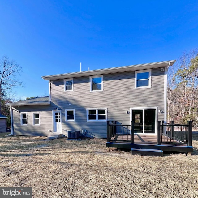 back of house with a deck and central air condition unit