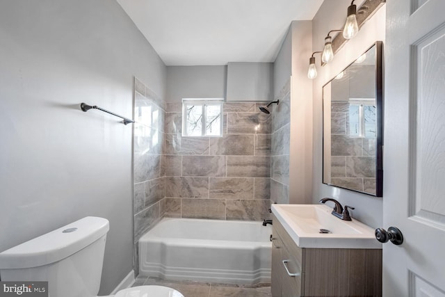 full bathroom featuring vanity, toilet, and tiled shower / bath