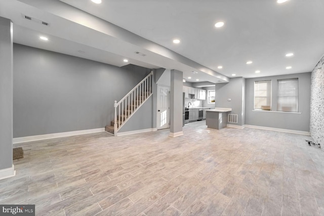 unfurnished living room with light wood-type flooring