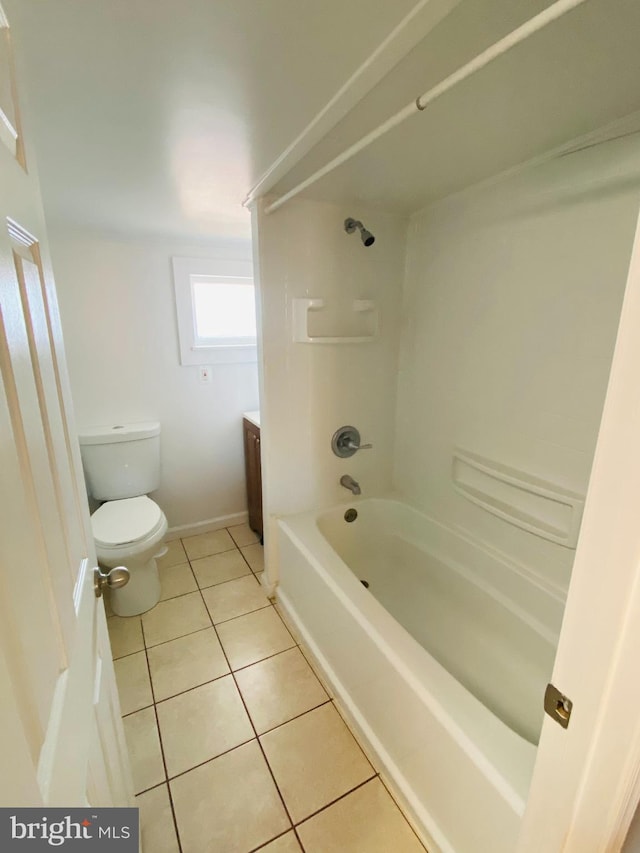 full bathroom featuring toilet, vanity, tile patterned floors, and shower / tub combination