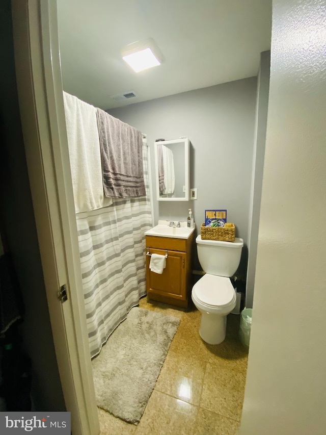 bathroom with vanity and toilet