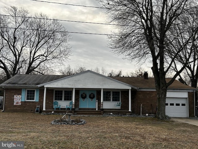 view of front of home featuring a porch and a garage