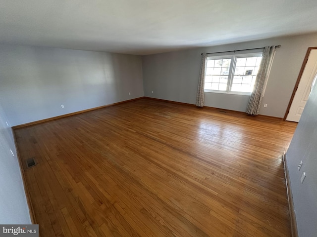 unfurnished room with light hardwood / wood-style floors