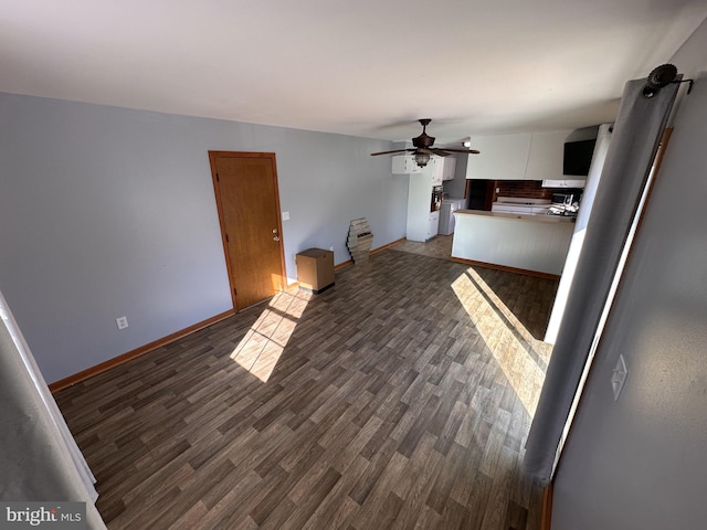 unfurnished living room featuring ceiling fan, washer / clothes dryer, and dark hardwood / wood-style floors