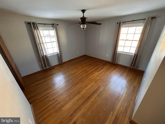 unfurnished room featuring ceiling fan and hardwood / wood-style floors