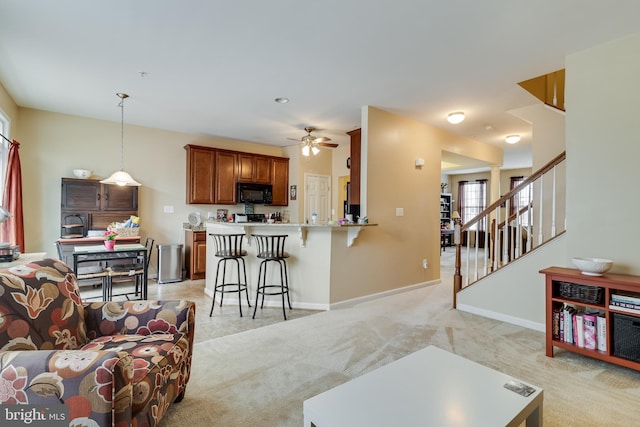 living room featuring light carpet and ceiling fan