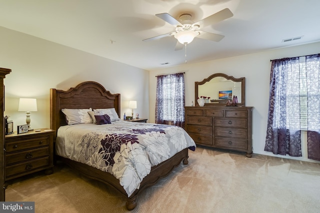 bedroom with ceiling fan and light colored carpet