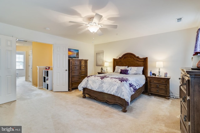 bedroom featuring light carpet and ceiling fan