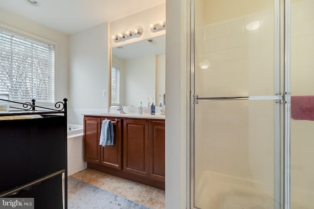 bathroom with tile patterned floors, vanity, and independent shower and bath