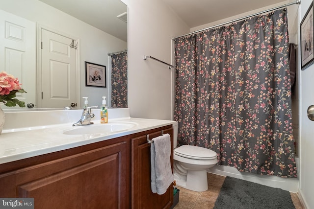 bathroom featuring vanity, curtained shower, tile patterned floors, and toilet