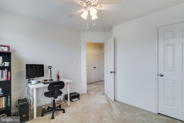 carpeted office space with ceiling fan