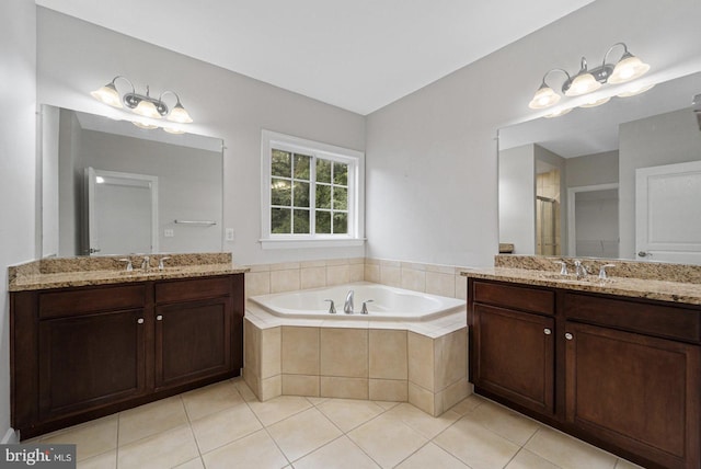 bathroom featuring plus walk in shower, vanity, and tile patterned floors