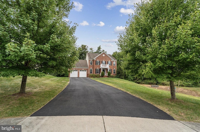 view of front of house with a garage and a front lawn