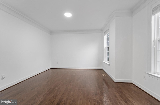 spare room with crown molding and dark hardwood / wood-style floors